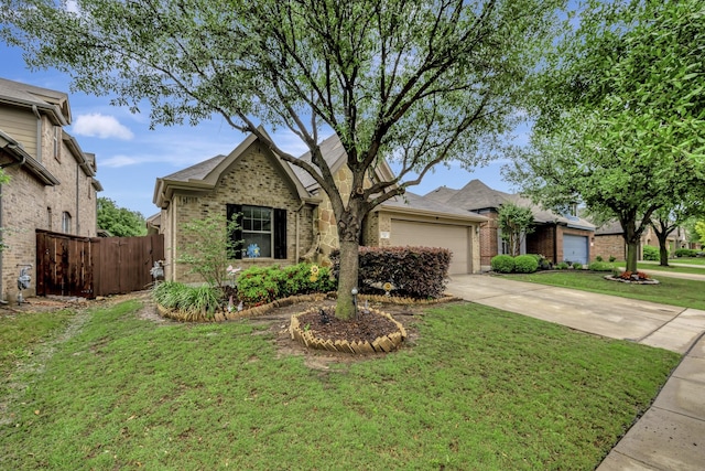 view of front of property featuring brick siding, driveway, a front lawn, and a garage