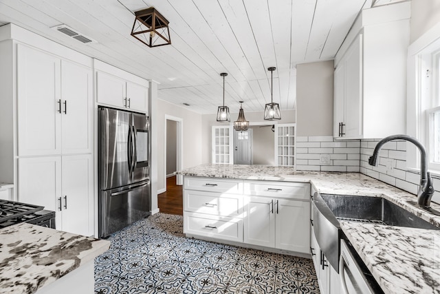 kitchen featuring visible vents, smart refrigerator, a sink, wooden ceiling, and white cabinetry