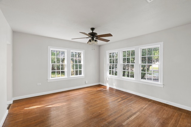 empty room with baseboards, ceiling fan, and hardwood / wood-style flooring