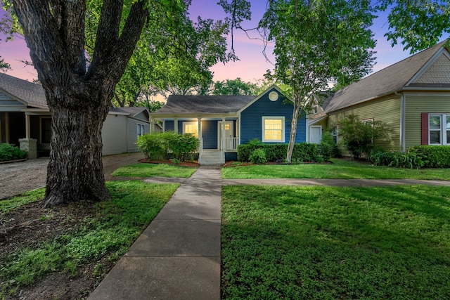 single story home featuring a porch and a front yard
