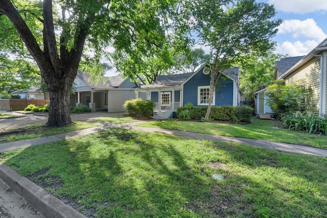 single story home featuring a shingled roof, a front lawn, and fence