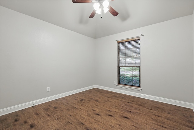 spare room with baseboards, dark wood-style flooring, ceiling fan, and lofted ceiling