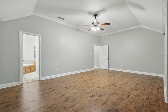 unfurnished bedroom with visible vents, ornamental molding, wood finished floors, and lofted ceiling