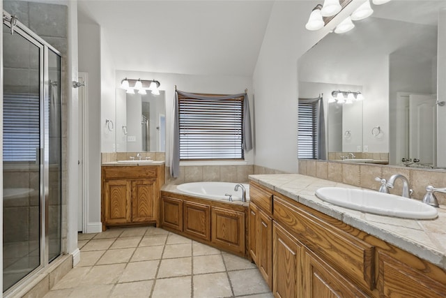 full bath featuring two vanities, a shower stall, a sink, and a bath