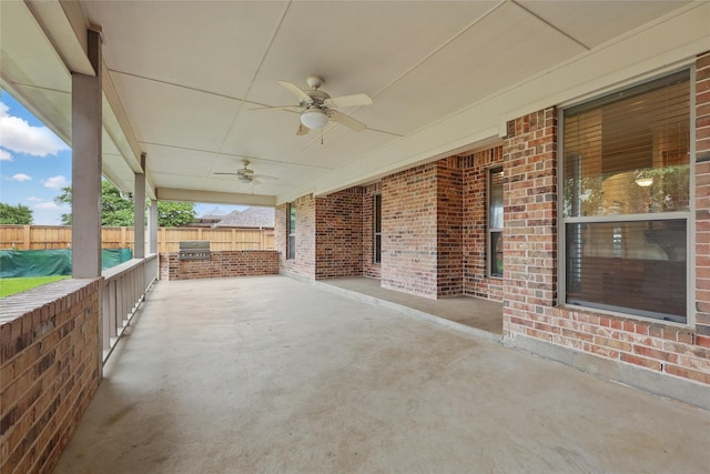 view of patio featuring area for grilling, ceiling fan, and fence