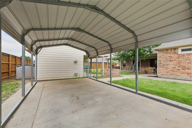 view of parking / parking lot featuring fence and a carport