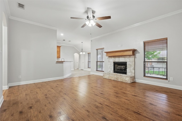 unfurnished living room featuring light wood-style floors, baseboards, ceiling fan with notable chandelier, and visible vents
