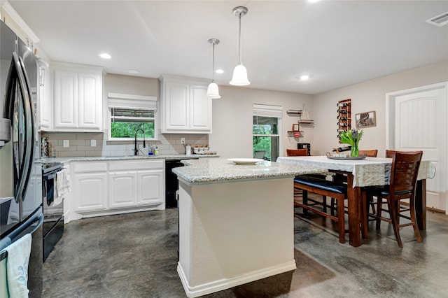 399 Wild Hill Oak Dr, Springtown, TX 76082 - kitchen featuring a healthy amount of sunlight, concrete flooring, and black appliances