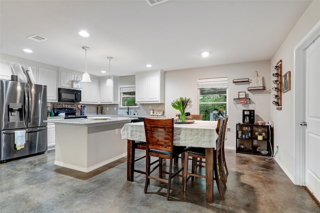 399 Wild Hill Oak Dr, Springtown, TX 76082 - kitchen with visible vents, concrete floors, a wealth of natural light, and black appliances