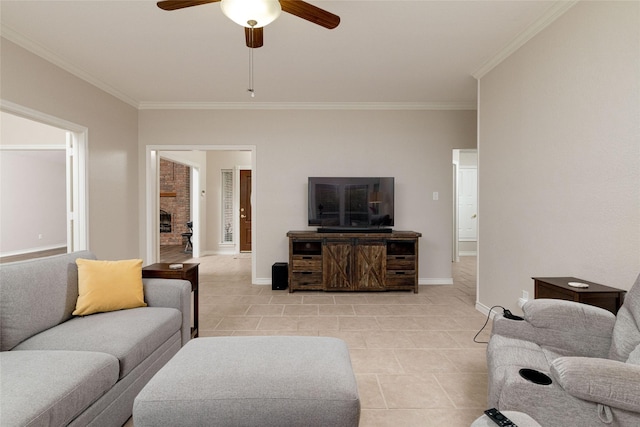 living room with baseboards, ornamental molding, a ceiling fan, and light tile patterned flooring