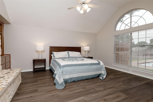 bedroom with baseboards, ceiling fan, wood finished floors, and high vaulted ceiling