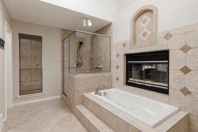 full bath with a tub with jets, tile patterned flooring, a stall shower, and a tiled fireplace