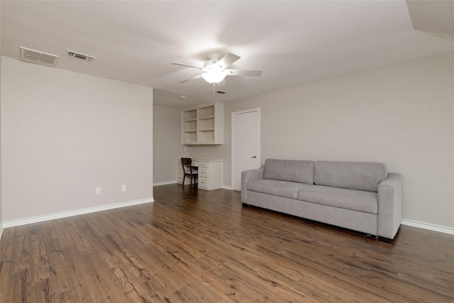 living area featuring visible vents, baseboards, ceiling fan, and wood finished floors