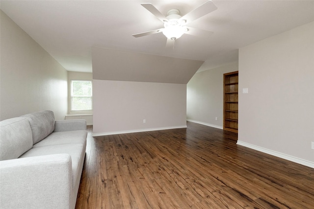 unfurnished living room featuring baseboards, a ceiling fan, lofted ceiling, and dark wood-style floors
