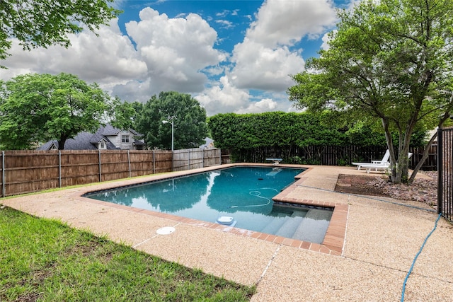 view of swimming pool with a fenced in pool, a fenced backyard, and a patio area
