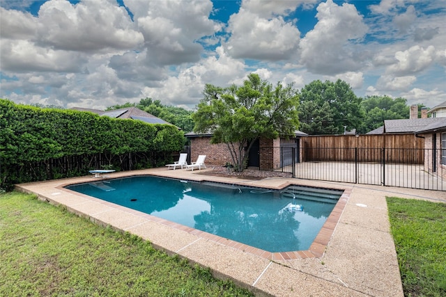 view of swimming pool featuring a patio, fence, and a fenced in pool