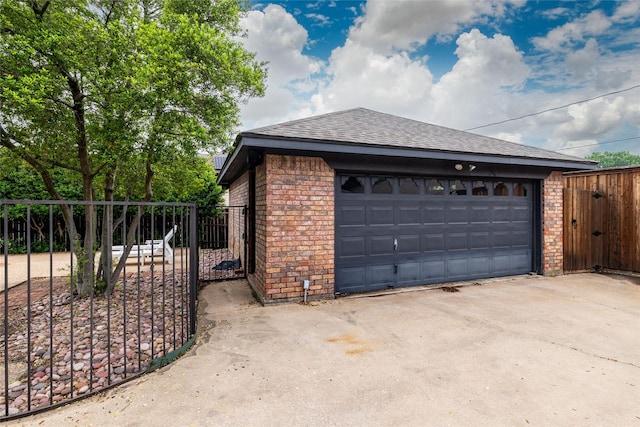 garage with fence and a gate