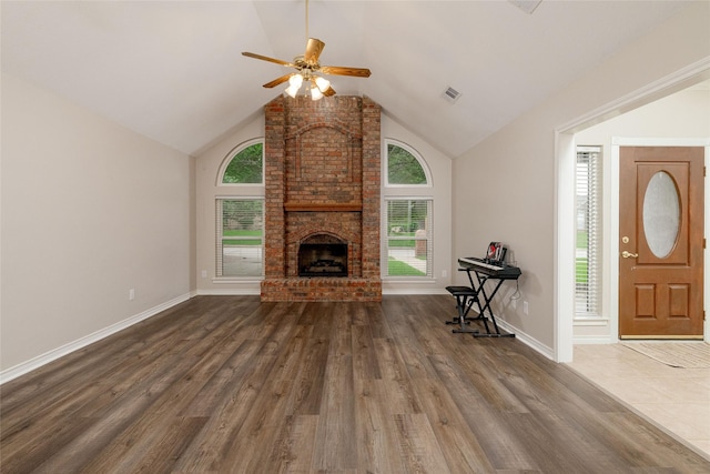unfurnished living room featuring visible vents, ceiling fan, wood finished floors, and a wealth of natural light