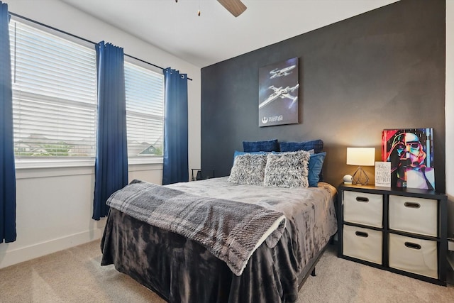 bedroom featuring baseboards, carpet flooring, and a ceiling fan