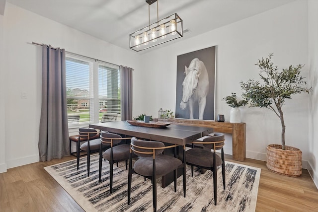 dining room featuring baseboards and light wood-style floors