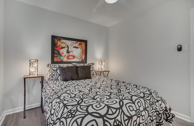 bedroom featuring baseboards, a ceiling fan, and wood finished floors