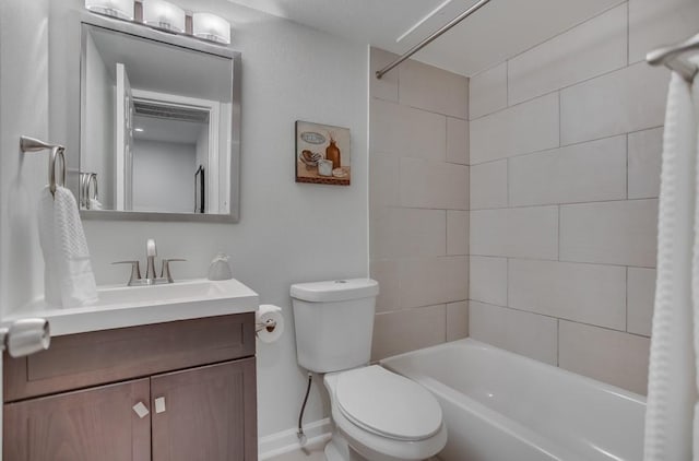 full bath featuring toilet, baseboards, washtub / shower combination, and vanity