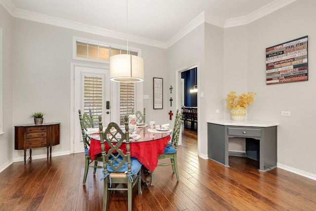 dining room featuring crown molding, baseboards, and hardwood / wood-style floors