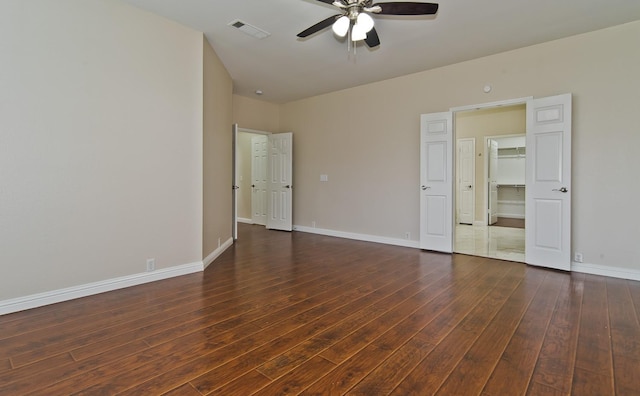 unfurnished bedroom with a ceiling fan, baseboards, visible vents, and hardwood / wood-style floors