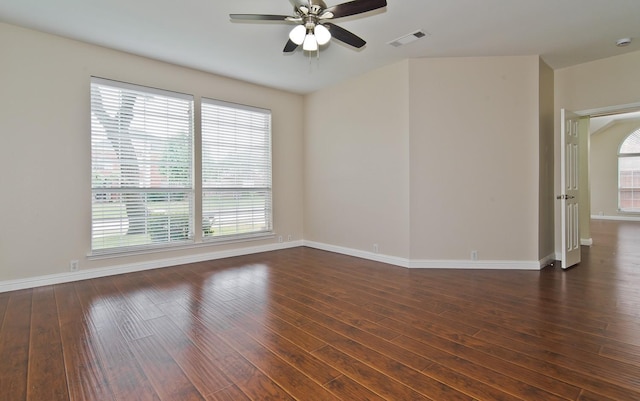 spare room with visible vents, baseboards, ceiling fan, hardwood / wood-style flooring, and a wealth of natural light