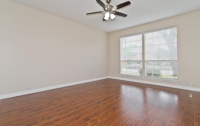 spare room featuring baseboards, a ceiling fan, and wood finished floors