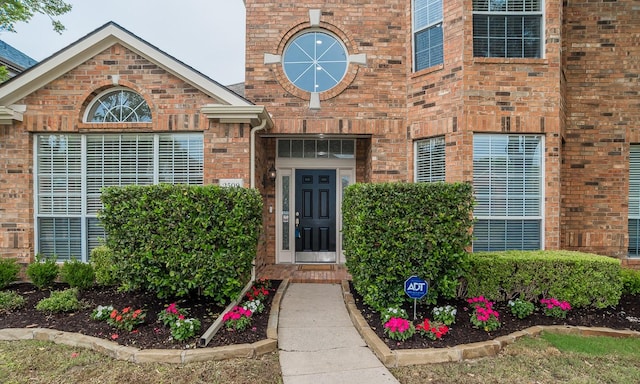 property entrance featuring brick siding