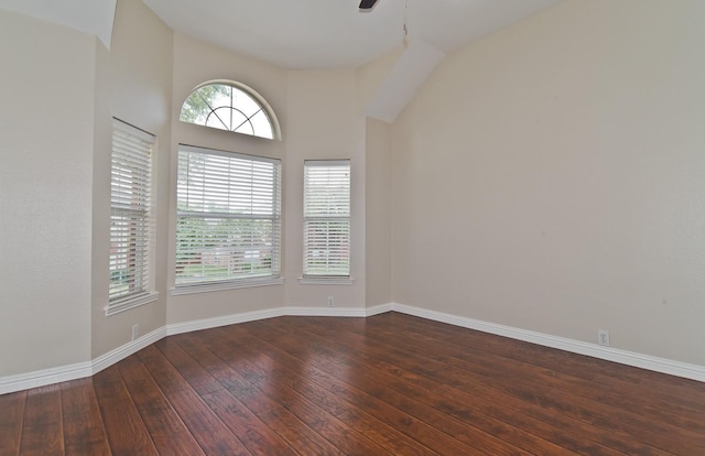 unfurnished room featuring baseboards, ceiling fan, lofted ceiling, and hardwood / wood-style floors