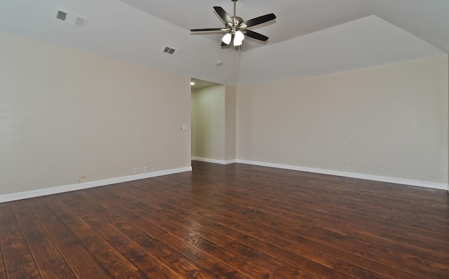 empty room with visible vents, a ceiling fan, dark wood finished floors, and lofted ceiling