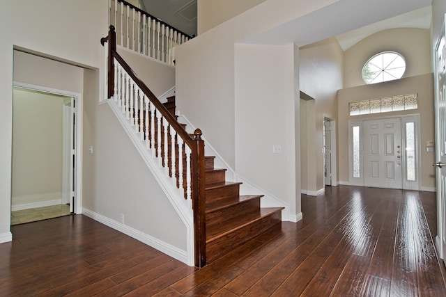 entrance foyer featuring stairway, a high ceiling, baseboards, and hardwood / wood-style flooring