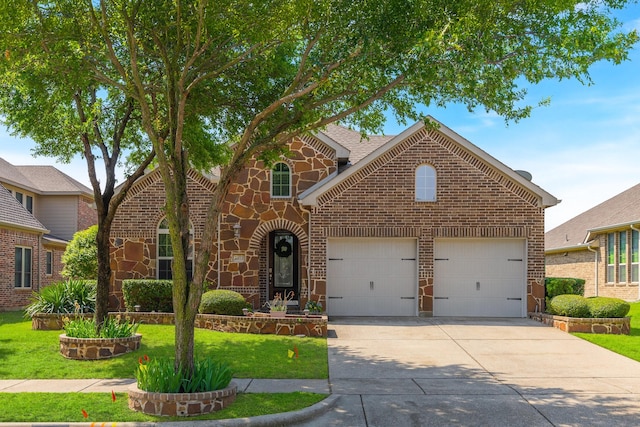 2308 Patriot Dr, Melissa, TX 75454 - traditional-style house featuring a garage, a front lawn, stone siding, brick siding, and driveway