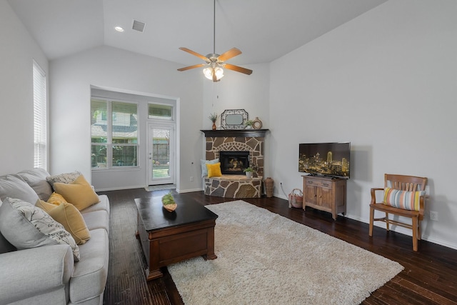 2308 Patriot Dr, Melissa, TX 75454 - living room featuring ceiling fan, a stone fireplace, visible vents, vaulted ceiling, and dark wood-style floors
