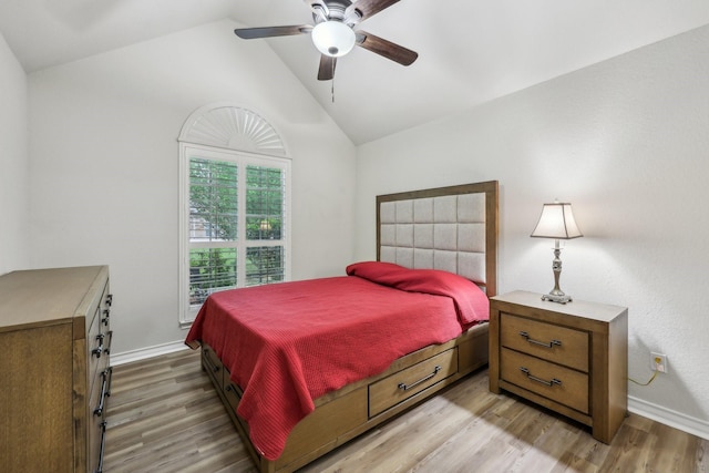 bedroom with baseboards, ceiling fan, light wood finished floors, and lofted ceiling