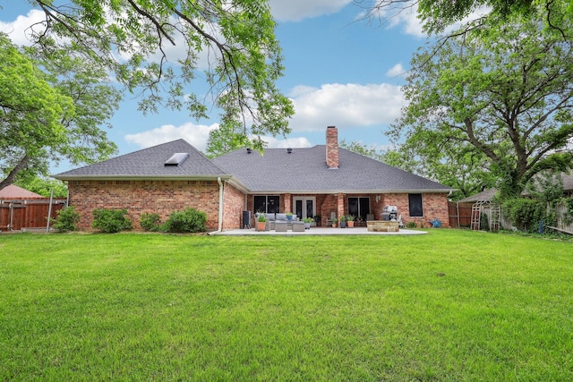 back of property with brick siding, a fenced backyard, a yard, and an outdoor hangout area
