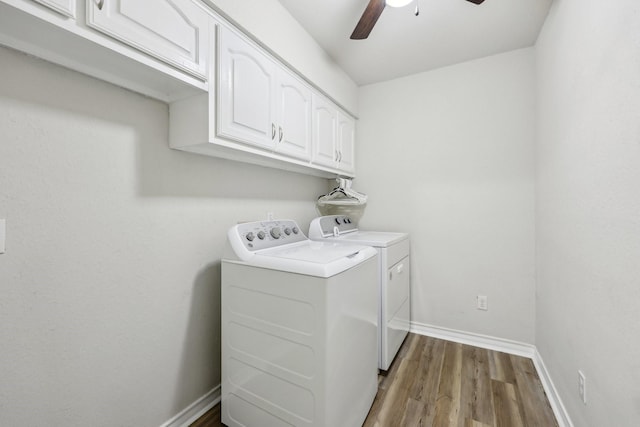 clothes washing area with wood finished floors, baseboards, ceiling fan, cabinet space, and independent washer and dryer