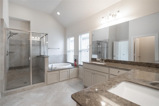 full bath with a bath, tile patterned floors, a sink, a stall shower, and vaulted ceiling