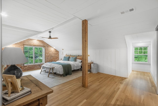 417 N Waddill St, Mckinney, TX 75069 - bedroom featuring multiple windows, light wood-style flooring, wooden walls, vaulted ceiling, and brick wall
