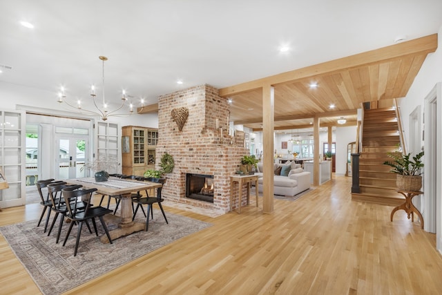 417 N Waddill St, Mckinney, TX 75069 - dining space featuring light wood-type flooring, a brick fireplace, recessed lighting, a chandelier, and stairway