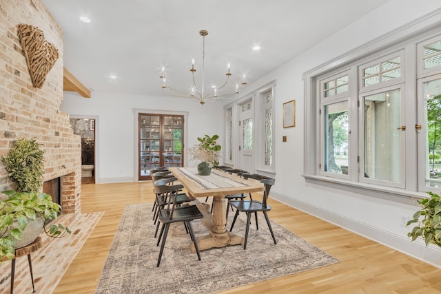 417 N Waddill St, Mckinney, TX 75069 - dining space with a chandelier, light wood finished floors, baseboards, a brick fireplace, and recessed lighting
