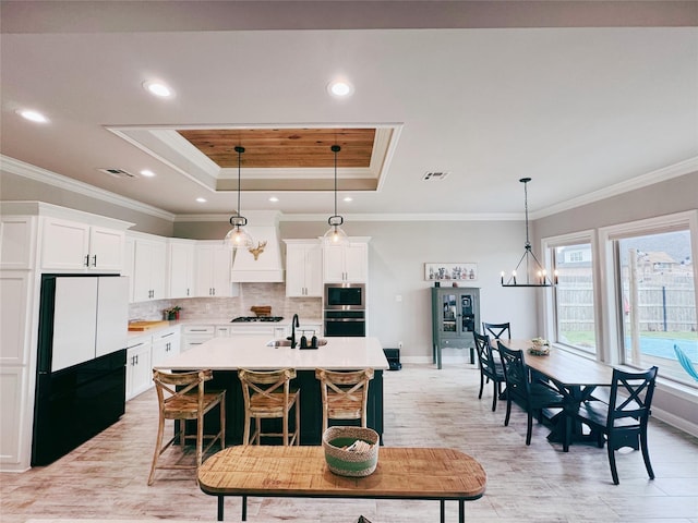 232 Conti Way, Bossier City, LA 71111 - kitchen with a tray ceiling, oven, freestanding refrigerator, baseboards, and stainless steel microwave
