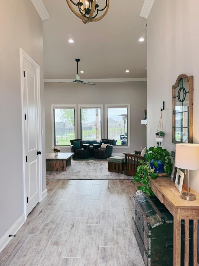 foyer featuring crown molding, recessed lighting, wood finished floors, and ceiling fan with notable chandelier