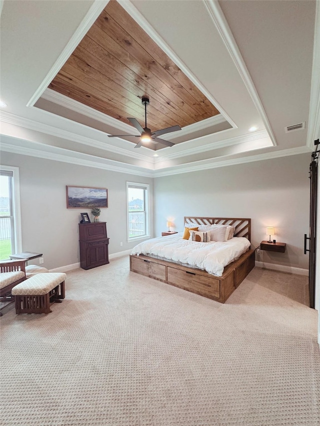 carpeted bedroom featuring crown molding, visible vents, and a raised ceiling