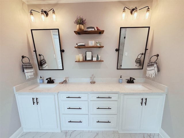 bathroom featuring double vanity, a sink, marble finish floor, and baseboards