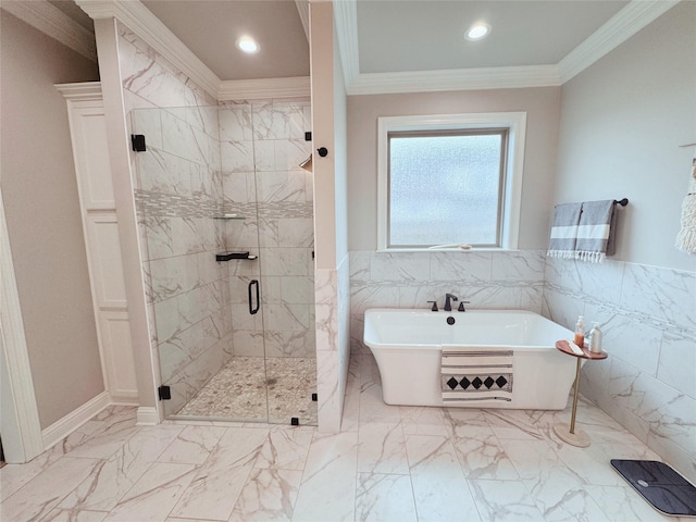 full bathroom with crown molding, marble finish floor, a freestanding tub, tile walls, and a stall shower
