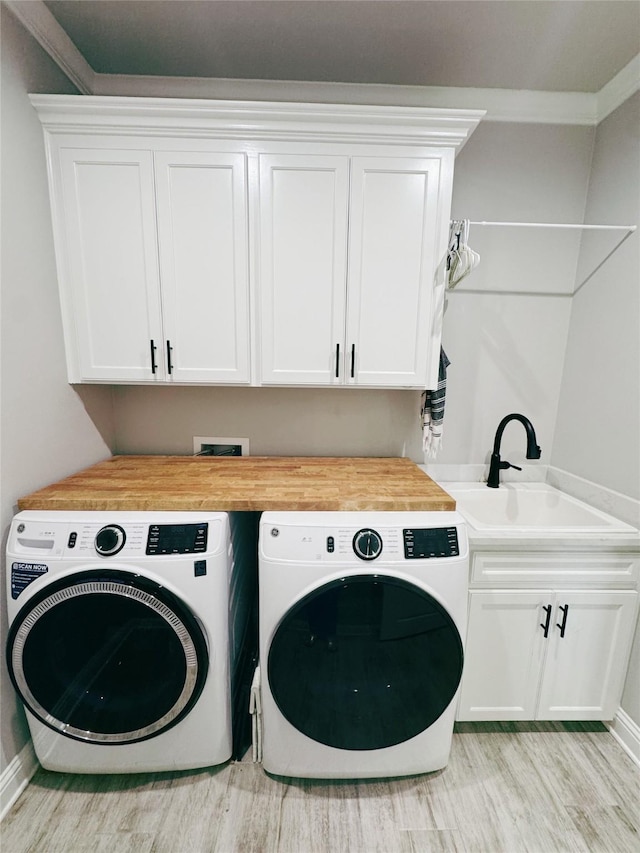 232 Conti Way, Bossier City, LA 71111 - laundry room with washer and clothes dryer, light wood finished floors, cabinet space, and baseboards