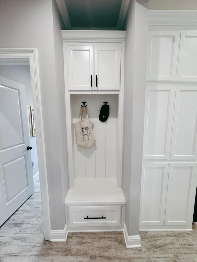 mudroom featuring baseboards and light wood-style flooring